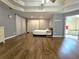 Spacious primary bedroom featuring hardwood floors, tray ceilings, and large windows at 1988 Greensferry Gln, Lawrenceville, GA 30043