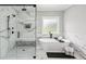 Elegant bathroom with a standalone tub, glass shower, and marble surround at 2243 Cain Cir, Dacula, GA 30019