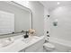 Bright bathroom featuring marble tile, a modern vanity, and sleek black fixtures at 2243 Cain Cir, Dacula, GA 30019