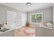 Cozy bedroom with hardwood floors, a crib, and natural light at 2243 Cain Cir, Dacula, GA 30019