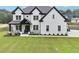 Stunning two-story home with a well-manicured lawn and a charming front porch at 2243 Cain Cir, Dacula, GA 30019