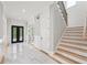 Grand foyer entrance with marble tile flooring and staircase at 2243 Cain Cir, Dacula, GA 30019