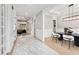 Bright hallway leading to a dining room and living room, featuring marble and hardwood flooring at 2243 Cain Cir, Dacula, GA 30019