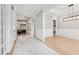 Bright hallway leading to a dining room and living room, featuring marble and hardwood flooring at 2243 Cain Cir, Dacula, GA 30019