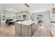 Open-concept kitchen featuring a large island, stainless steel appliances, and backyard view at 2243 Cain Cir, Dacula, GA 30019