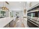 Open-concept kitchen features a large island, stainless steel appliances, and a view into the living room at 2243 Cain Cir, Dacula, GA 30019