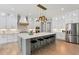 Bright kitchen featuring an island with barstool seating, pendant lighting, and stainless steel appliances at 2243 Cain Cir, Dacula, GA 30019