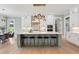 Bright kitchen with a large island, barstool seating, pendant lights, and dining area at 2243 Cain Cir, Dacula, GA 30019