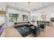 Open-concept living room featuring large windows, hardwood floors, and seamless connection to the kitchen at 2243 Cain Cir, Dacula, GA 30019