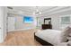 Spacious primary bedroom with light hardwood floors and a large flatscreen television at 2243 Cain Cir, Dacula, GA 30019