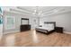 Spacious main bedroom featuring tray ceilings, light hardwood floors, and ensuite bathroom at 2243 Cain Cir, Dacula, GA 30019