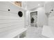 Beautiful mudroom features shiplap, storage, bench seating, and tile flooring at 2243 Cain Cir, Dacula, GA 30019