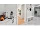 Stylish mudroom area with a built-in bench, shelving, and easy access to kitchen at 2243 Cain Cir, Dacula, GA 30019
