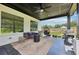 Covered patio area with outdoor seating, a grill, and a view of the backyard at 2243 Cain Cir, Dacula, GA 30019