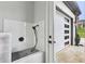 Modern walk-in shower features sleek tiling and contemporary fixtures near the garage door at 2243 Cain Cir, Dacula, GA 30019