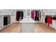 Large walk-in closet with custom shelving and center storage island at 2243 Cain Cir, Dacula, GA 30019