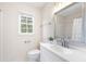 Bright bathroom featuring a white vanity, a window, and a framed mirror at 4522 Reva Ne Ct, Marietta, GA 30066