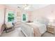 A tranquil pink bedroom with natural light, a cozy chair, and charming decor at 4522 Reva Ne Ct, Marietta, GA 30066