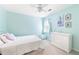 Comfortable bedroom painted in light blue, decorated with a window, and a white dresser at 4522 Reva Ne Ct, Marietta, GA 30066