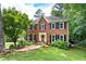 Traditional brick home with black shutters and a well-manicured lawn at 4522 Reva Ne Ct, Marietta, GA 30066