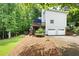 View of house exterior featuring backyard deck, garage, and lush green landscaping at 4522 Reva Ne Ct, Marietta, GA 30066