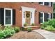 Charming brick home entrance with a decorative wreath and manicured landscaping at 4522 Reva Ne Ct, Marietta, GA 30066