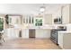 Bright kitchen features white cabinets, stainless steel appliances, and hardwood floors at 4522 Reva Ne Ct, Marietta, GA 30066
