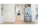 Pantry and stainless steel refrigerator for kitchen storage with hardwood floors and modern look at 4522 Reva Ne Ct, Marietta, GA 30066