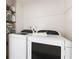 Efficient laundry room featuring modern washer and dryer units and ample shelving for storage at 4522 Reva Ne Ct, Marietta, GA 30066
