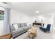 Bright living room with neutral tones, comfortable seating, and a functional desk space for work or study at 4522 Reva Ne Ct, Marietta, GA 30066