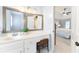 Main bathroom featuring a makeup vanity, a view into the main bedroom, and a large mirror at 4522 Reva Ne Ct, Marietta, GA 30066