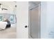 Main bathroom featuring a white-framed shower with translucent glass and a view into the main bedroom at 4522 Reva Ne Ct, Marietta, GA 30066