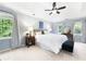 Serene main bedroom featuring a trey ceiling, ceiling fan, and large windows with backyard views at 4522 Reva Ne Ct, Marietta, GA 30066