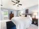 Bright main bedroom offering a trey ceiling, a ceiling fan, carpet floors, and backyard views at 4522 Reva Ne Ct, Marietta, GA 30066