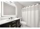 Sleek bathroom features a vanity with modern fixtures and a shower with a white curtain for a clean aesthetic at 900 Ira Sw St, Atlanta, GA 30310