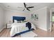 Beautiful bedroom features a blue upholstered bed, modern decor, and soft lighting, offering a cozy and inviting atmosphere at 900 Ira Sw St, Atlanta, GA 30310