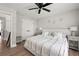 Comfortable bedroom featuring a plush white bed, wood floors, ceiling fan, and modern decor for a serene ambiance at 900 Ira Sw St, Atlanta, GA 30310