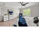 Elegant bedroom showcasing a blue upholstered bed, a large window, and contemporary furnishings, creating a comfortable retreat at 900 Ira Sw St, Atlanta, GA 30310