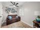 Cozy room with comfortable brown futon and a fan at 900 Ira Sw St, Atlanta, GA 30310