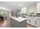 Sunlit kitchen boasting white cabinets, gray backsplash, island with a white countertop, and stainless steel appliances at 900 Ira Sw St, Atlanta, GA 30310