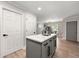 A kitchen island featuring a gray base, white countertop, and stylish cabinets, complemented by stainless steel appliances at 900 Ira Sw St, Atlanta, GA 30310