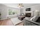 Inviting living room featuring hardwood floors, a fireplace, and comfortable gray seating near a bright window at 900 Ira Sw St, Atlanta, GA 30310