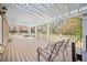 Outdoor back porch area with a wood ceiling and railing and seating at 1561 Annapolis Way, Grayson, GA 30017
