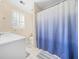 Bathroom with a white vanity and blue gradient shower curtain at 1561 Annapolis Way, Grayson, GA 30017