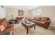 Comfortable living room featuring plush sofas, elegant decor, and a large window at 1561 Annapolis Way, Grayson, GA 30017
