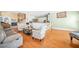 Spacious living room with hardwood floors and view into kitchen area with bar seating at 1561 Annapolis Way, Grayson, GA 30017