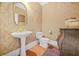 Elegant powder room with pedestal sink, ornate mirror, and stylish wallpaper at 1561 Annapolis Way, Grayson, GA 30017