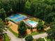 Aerial view of community tennis courts, pool, and recreational area surrounded by lush trees at 270 Hollyridge Way, Roswell, GA 30076