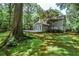 Expansive backyard with lush greenery, a spacious deck, and mature trees, ideal for outdoor entertaining at 270 Hollyridge Way, Roswell, GA 30076