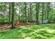 Beautifully landscaped backyard featuring mature trees, playground and storage shed at 270 Hollyridge Way, Roswell, GA 30076